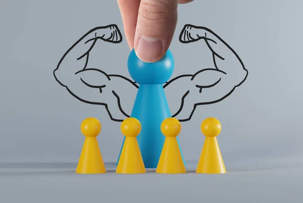 Yellow pawns and a blue pawn with drawn muscles. Diversity, racism and discrimination issues concept. Creative activities and team work.