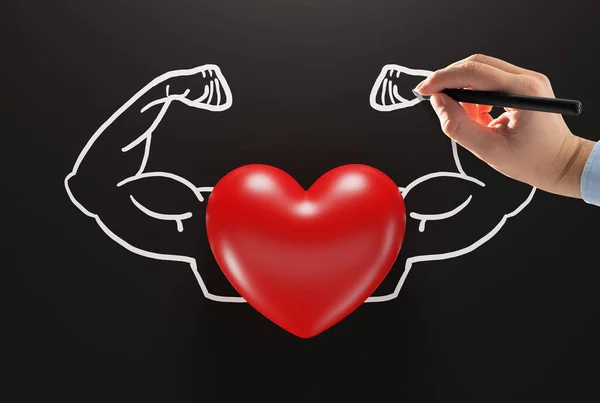 Heart on the background of drawn by hand muscles. The concept of a strong and healthy heart, taking care of your physical condition.