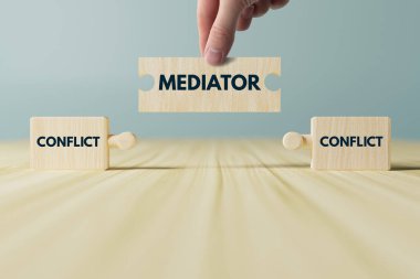 Wooden blocks, puzzles with the word conflict and a mediator that connects them. The concept of mediation, helping to resolve disputes, conflicts. clipart