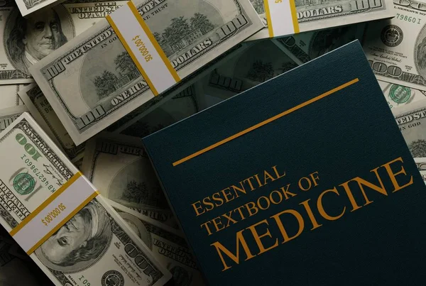 Book, textbook for medicine on the background of money. The concept of medical education costs, funds for medical studies. 3D render, 3D illustration.