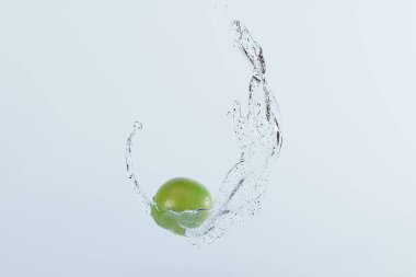 Lime on impact with water, in a splash. Concept of eating fruit, using lime. 3D render, 3D illustration.
