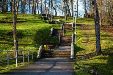Modern multilevel stone staircase in the park, cement step walkway