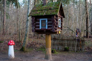 A hut on chicken legs stands in a fairy-tale, magical forest.