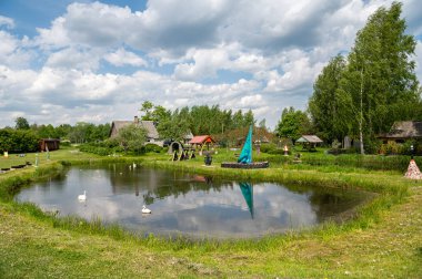 Litene Parish, Gulbene County, Letonya - 25 Mayıs. 2023: Şişe bahçesi veya açık havada cam şişelerden yapılmış çeşitli çevresel nesneler