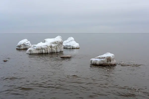 Landscape with ice hummocks and snow on a frozen Baltic Sea surface on a cold winter day