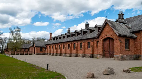 stock image Zagare manor red brick stud farm complex on a sunny spring day, Lithuania