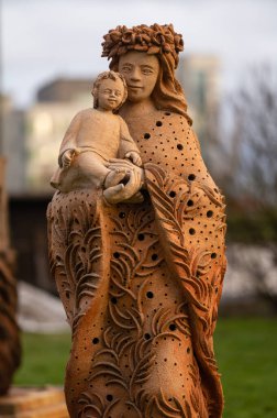 Jelgava, Latvia - January. 14. 2023:  A sculpture of a mother with a child. Large Format Sand Sculpture Symposium clipart
