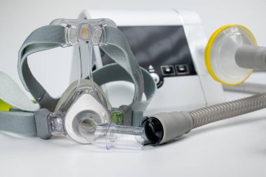 Continuous positive airway pressure system includes of CPAP machine, mask, tube on white background. clipart