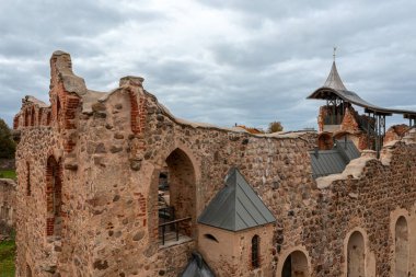 A detailed look at the stone remains of a medieval fortress with a tower. clipart