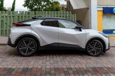 Talsi, Letonya - 1 Eylül 2024: Toyota C-HR modelinin yeni tasarımı kaldırımlı bir caddenin kenarına park edildikten sonra