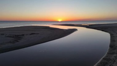 İnsansız hava aracı, sakin denizin üzerinde nefes kesici bir gün doğumu yakalar. Sabah güzelliği ve sakinliği gözler önüne serer..