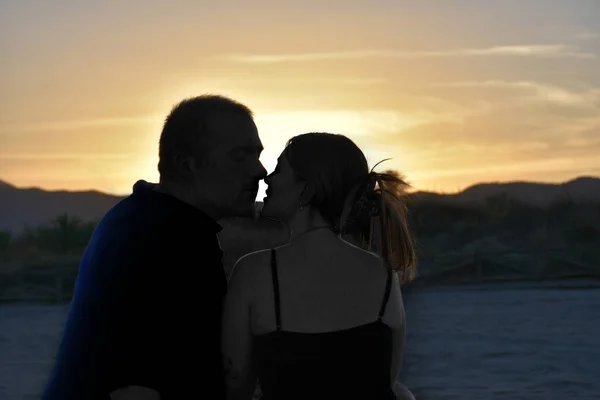 Back view of romantic couple at sunset