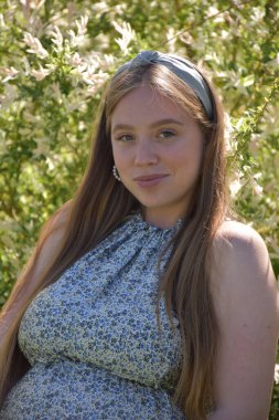 Arka planda hamile bir kadın var.,