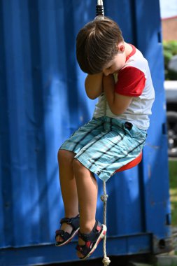 boy playing on the swing child riding on swing in park, clipart