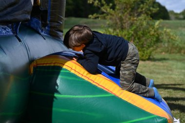 Çocuk balonla oynuyor. Çocuklar şişme trambolinde oynuyor.