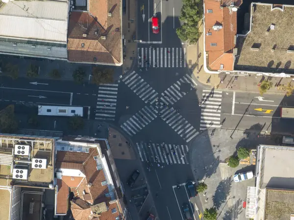 Top view over a crowd pedestrian crossing road intersection, Belgrade. Aerial view od traffic at busy scramble crosswalk. High quality Photo