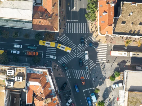 Top view over a crowd pedestrian crossing road intersection, Belgrade. Aerial view od traffic at busy scramble crosswalk. High quality Photo