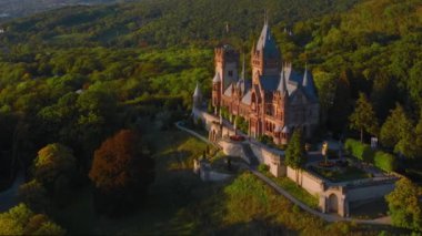 Drachenburg Siebengebirge kalesinin hava görüntüsü gün batımında Nord-Rhein Westfell 'de Bonn yakınlarında. Konigswinter Yüksek kalite 4K görüntü