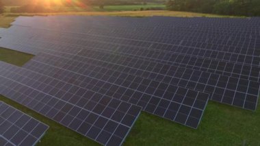 Photovoltaik Panelleri olan güneş enerjisini elektriğe çeviren bir güneş çiftliği. Günbatımında Danimarka 'da yeşil enerji. Havadan. Yüksek kalite 4k görüntü
