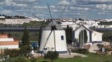Sunny Day 'de Algarve' deki Eski Beyaz Portekiz yel değirmeninin üzerinde uçarken, Hava Aracı Atışı. Yüksek kalite 4k görüntü