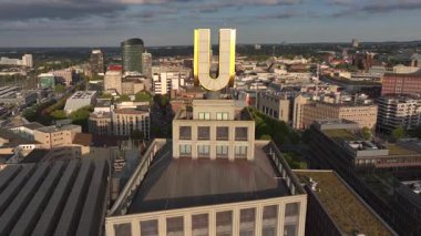 Dortmund U-Tower in Evening, Aerial Drone Shot. City skyline on the background in sunny day. 4k UHD