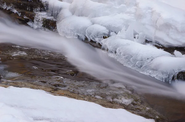 Frozen waterfall. Ice waterfall. Waterfall in winter. Winter cascade. Mountain stream