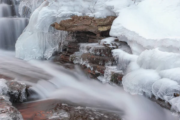 Frozen waterfall. Ice waterfall. Waterfall in winter. Winter cascade. Mountain stream