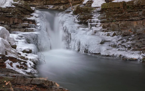 Frozen waterfall. Ice waterfall. Waterfall in winter. Winter cascade. Mountain stream