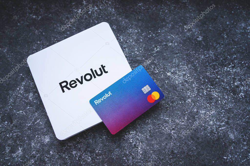Revolut Bank card with the white envelope. New redesigned Revolut Mastercard without card details on concrete background. Krakow, Poland - November 11, 2022.