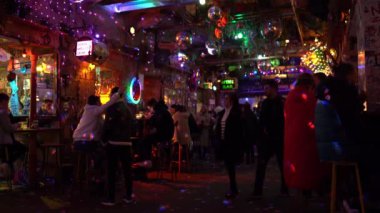 Interior of Szimpla Kert, famous ruin pub in Budapest at night. Nightlife, hungarian bars concept. Budapest, Hungary - February 2, 2023.