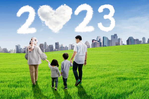 Muslim Family Holding Hands Together While Walking Meadow Clouds Shaped — Stock Photo, Image