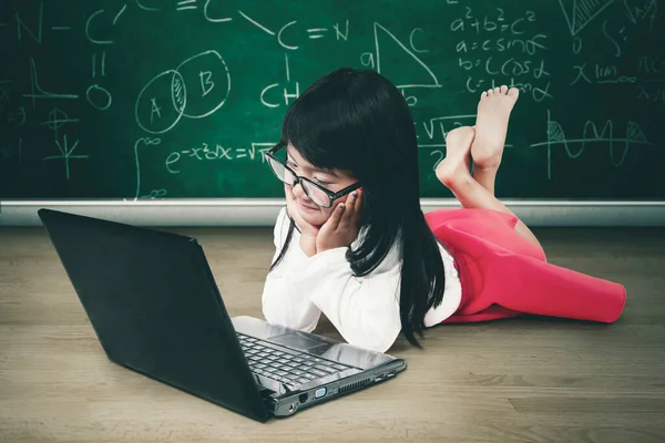 Pensive Schoolgirl Using Laptop While Lying Class Doodles Background — Stock Photo, Image