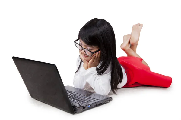 Pensive Schoolgirl Using Laptop While Lying Studio Isolated White Background — Stock Photo, Image