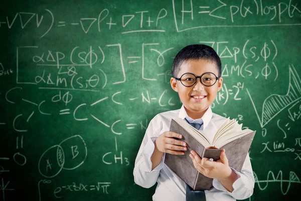 Cheerful Schoolboy Reading Textbook While Standing Doodles Background Classroom Stock Photo