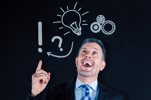 Happy Male Manager Getting Idea While Pointing Light Bulb Gears — Stock Photo, Image