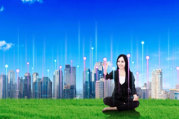 Happy Businesswoman Sitting Grass Touching Screen Cityscape Background — Stock Photo, Image
