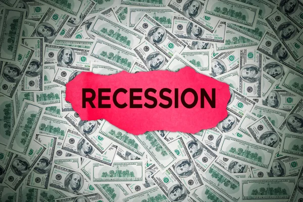 Business and recession fears - Word Recession on top of banknotes