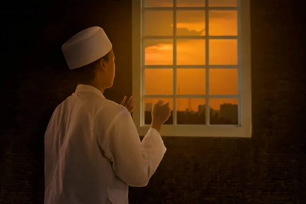 Moslim Man Biddend Bij Het Raam Bij Zonsondergang — Stockfoto