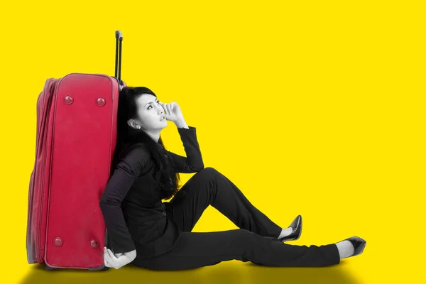 Businesswoman sitting on the floor with a suitcase collage in magazine style. Contemporary art. Modern design