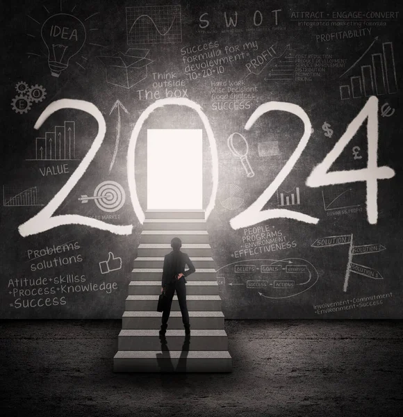 Rear view of businesswoman standing on the stairs toward a door with 2024 new year numbers and scribbles on the wall