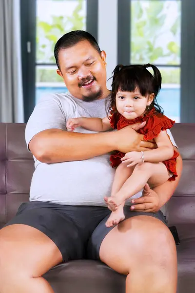 stock image Overweight Asian man at home with his little cute girl. Happy Father's Day!