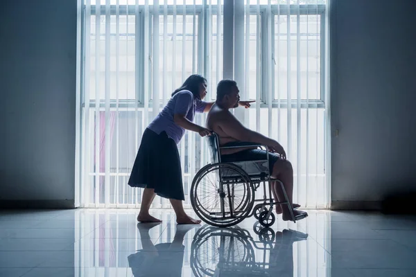 Overweight Man Sitting Wheelchair Being Pushed Female Nurse His Overweight — Stock Photo, Image