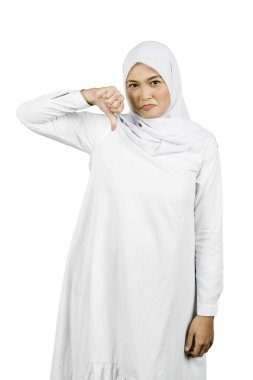 Unhappy Woman in White Hijab Giving a Thumbs-Down Gesture clipart