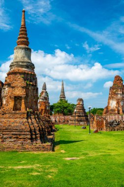 Ruins of ancient city and temples Ayutthaya, Thailand. Old kingdom of Siam. Summer day with blue sky. Famous tourist destination, spiritual place near Bangkok.