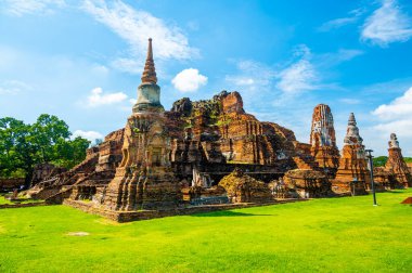 Ruins of ancient city and temples Ayutthaya, Thailand. Old kingdom of Siam. Summer day with blue sky. Famous tourist destination, spiritual place near Bangkok.