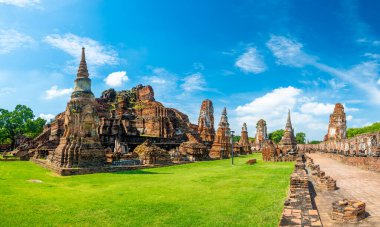 Ruins of ancient city and temples Ayutthaya, Thailand. Old kingdom of Siam. Summer day with blue sky. Famous tourist destination, spiritual place near Bangkok.