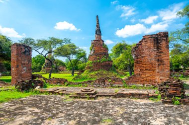 Ruins of ancient city and temples Ayutthaya, Thailand. Old kingdom of Siam. Summer day with blue sky. Famous tourist destination, spiritual place near Bangkok.