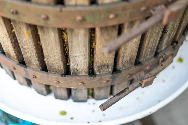 Detail view of mechanical press used for fruit or pressing of wine grapes. Traditional vinery tool.