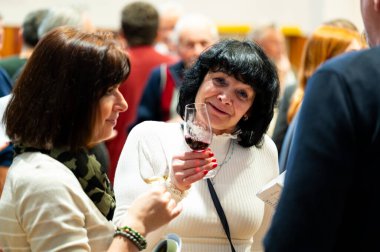 Hrusovany u Brna, Çek Cumhuriyeti - 17.2.2024: Şarap arıtma ve şarap tatma etkinliği. Bardaktan içen insanların görüntüsü. Güney Moravya bölgesi, Palava tepeleri yakınlarındaki şarap diyarı..