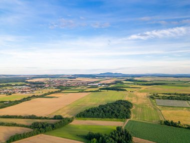 A stunning drone view of Hrusovany u Brna, showcasing the charming town, surrounding vineyards, and a distant, scenic view of the Palava Hills. clipart